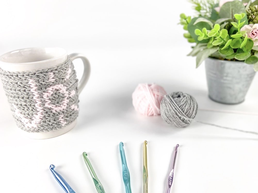 crochet hooks, mug and yarn